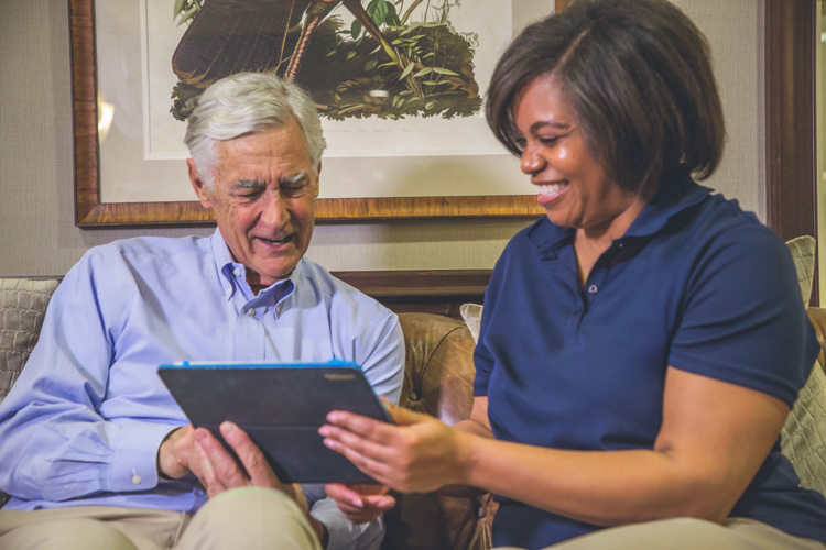 Employee talking to man with ipad
